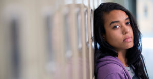 girl leaning against a locker