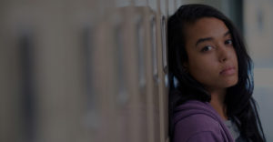 girl leaning on a locker