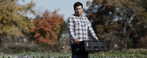 serious looking man holding a basket