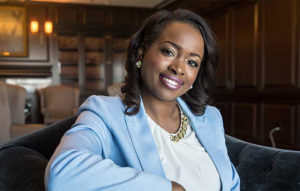 a woman in a blue suit smiling