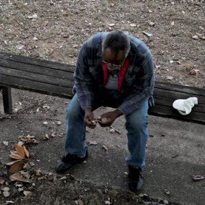 Howard Vulnerability. Older man sitting on a wooden bench