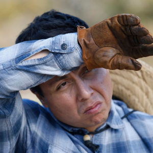 Jorge Story. wearing a flannel and gloves.