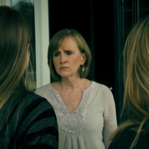 two girls at the doorstep of a womans house